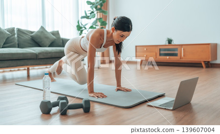 Young Asian woman doing sport exercises indoor 139607004