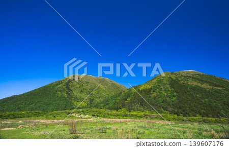 A view of the lush green mountains and blue sky from the western plains of Mt. Sanbe. A view of the lush green mountains and blue sky from the western plains of Mt. Sanbe. 139607176