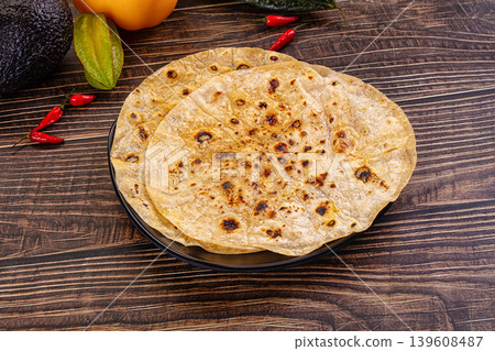 Toasted flatbread with fresh vegetables and chili peppers Toasted flatbread with fresh vegetables and chili peppers 139608487