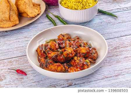 Plate of spicy glazed breaded prawn stir-fry with bell peppers and a side of yellow rice Plate of spicy glazed breaded prawn stir-fry with bell peppers and a side of yellow rice 139608503