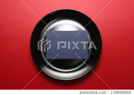 Black plate, navy blue paper, red background Black plate, navy blue paper, red background 139608608