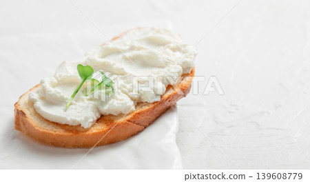 Toast with fresh cream cheese and microgreens on white background 139608779