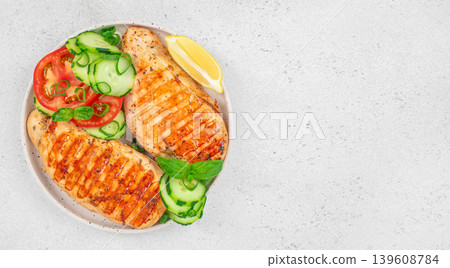 Top view of grilled chicken breast with fresh vegetables and copy space Top view of grilled chicken breast with fresh vegetables and copy space 139608784