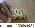 Hand Shaping Braided Dough Close Up 139609681
