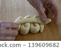 Hand Shaping Braided Dough Close Up 139609682