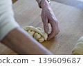 Hand Shaping Braided Dough Close Up 139609687
