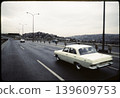 Vintage Cars Driving on Urban Highway Scene 139609753