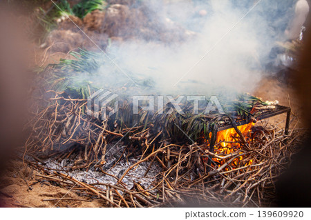 A traditional Catalan dish called calcots, a long spring onions, on barbecue during calcotada festivities in Tarragona province, Spain. A traditional Catalan dish called calcots, a long spring onions, on barbecue during calcotada festivities in Tarragona province, Spain. 139609920