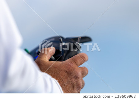Elderly men focused on remote control boat activity. Elderly men focused on remote control boat activity. 139609968