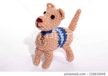 Knitted woolen dog on a white background Knitted woolen dog on a white background 139610008