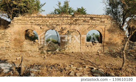 Abandoned temple wall features arched windows at tilla jogian heritage site pakistan Abandoned temple wall features arched windows at tilla jogian heritage site pakistan 139610180
