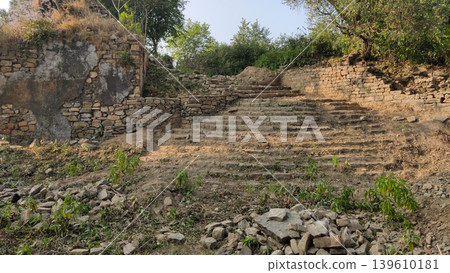 Broken stone steps lead to historic hindu ruins of tilla jogian pakistan Broken stone steps lead to historic hindu ruins of tilla jogian pakistan 139610181