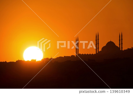 Sunset Silhouette of Istanbul Mosque. A breathtaking orange sunset behind the silhouette of a mosque and minarets on the Istanbul horizon. Perfect for travel and spirituality. Sunset Silhouette of Istanbul Mosque. A breathtaking orange sunset behind the silhouette of a mosque and minarets on the Istanbul horizon. Perfect for travel and spirituality. 139610349