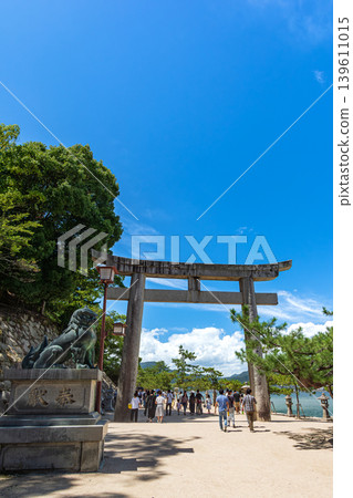 The large torii gate on the approach to Itsukushima Shrine stands out against the blue sky. The large torii gate on the approach to Itsukushima Shrine stands out against the blue sky. 139611015