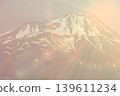 Snowy Mountain Sunrise Glow.Stunning snow-covered mountain peak glowing in sunrise light, editorial minimal style landscape highlighting natural grandeur and serene atmosphere. 139611234