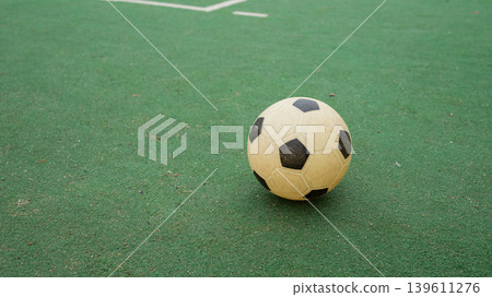 Classic black and white soccer ball on green field Classic black and white soccer ball on green field 139611276