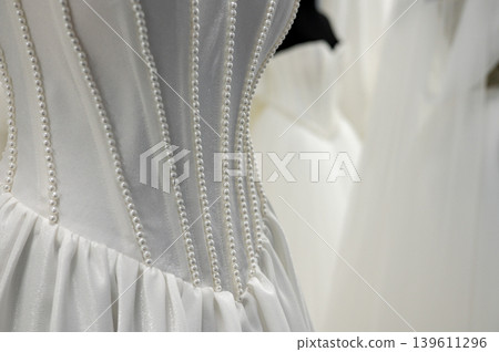 Close-up of elegant pearl embellished white wedding dress fabric National Wedding Month Close-up of elegant pearl embellished white wedding dress fabric National Wedding Month 139611296