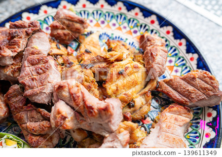 Grilled pork and chicken slices arranged on ceramic plate Grilled pork and chicken slices arranged on ceramic plate 139611349