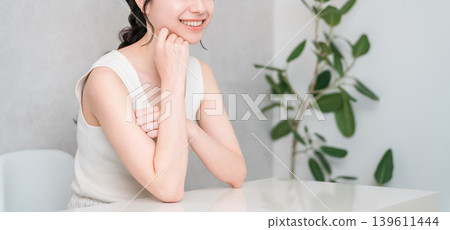 Smiling Asian woman with beautiful skin with a cheek (beauty, esthetic, skin care image) Smiling Asian woman with beautiful skin with a cheek (beauty, esthetic, skin care image) 139611444