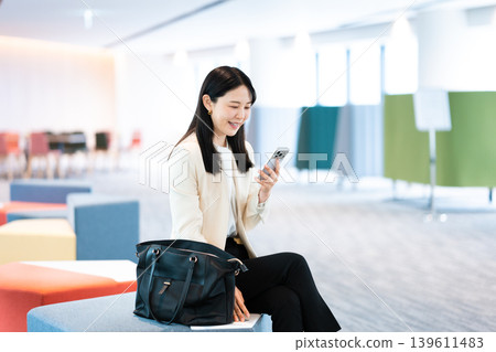 A woman using her smartphone at a client's home. A woman using her smartphone at a client's home. 139611483
