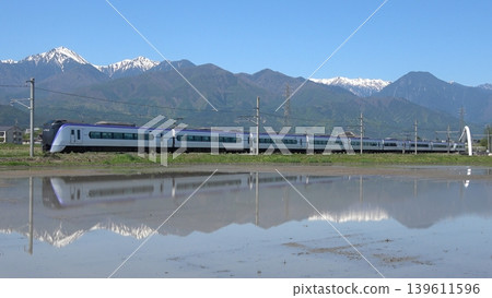 A limited express train runs against the backdrop of the snow-capped mountains of Shinshu. A limited express train runs against the backdrop of the snow-capped mountains of Shinshu. 139611596