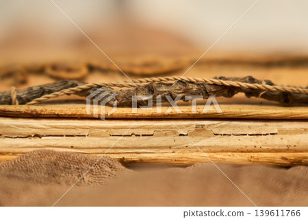 Antique document featuring tactile wear and warm tone. Historical object showcasing torn edges and nostalgic sepia ambiance 139611766