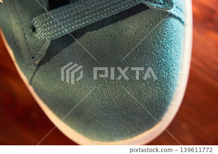 Sneaker sole stitching closeup showing welt and rubber midsole, textured suede upper and seam detail Sneaker sole stitching closeup showing welt and rubber midsole, textured suede upper and seam detail 139611772