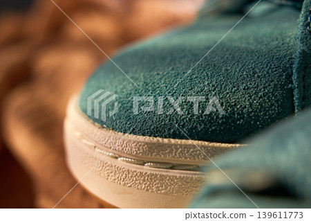 Sneaker sole stitching closeup showing welt and rubber midsole, textured suede upper and seam detail Sneaker sole stitching closeup showing welt and rubber midsole, textured suede upper and seam detail 139611773