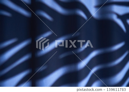 Soft ambient lighting shapes delicate fabric shadows. Vivid shadows cast by ambient light define textured fabric in dynamic visual effects 139611783