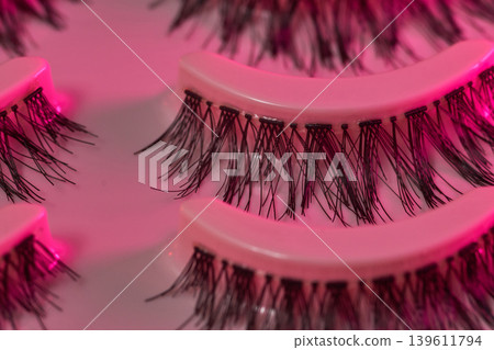 Lash display scene. Eyelash trays under vibrant neon illumination. Luxurious lash presentation using colorful ambient lighting effects 139611794
