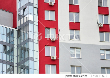 Minimalist cityscape: glass, concrete, and vibrant red wall details 139611802