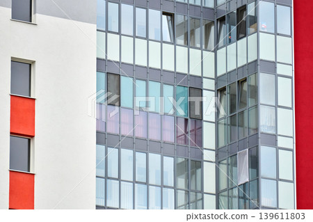 High-rise apartment exterior with reflective windows and modern design High-rise apartment exterior with reflective windows and modern design 139611803