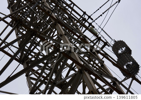 Industrial steel lattice tower structure with high-voltage power lines Industrial steel lattice tower structure with high-voltage power lines 139611805