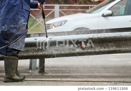 Daily city life: maintenance worker and elderly woman at a crosswalk Daily city life: maintenance worker and elderly woman at a crosswalk 139611806