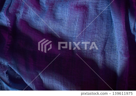 Colorful fabric with shadow patterns reflecting light in a studio setting during the day 139611975