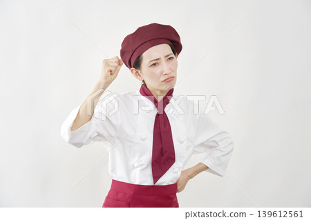 A female pastry chef clenching her fists in anger A female pastry chef clenching her fists in anger 139612561