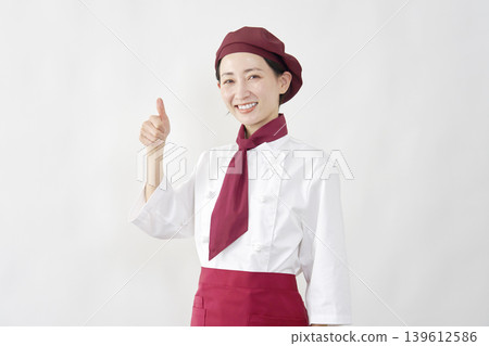 A smiling pastry chef giving a thumbs-up. A smiling pastry chef giving a thumbs-up. 139612586