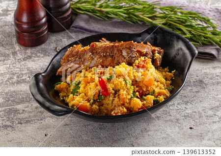 Couscous with ribs and vegetables Couscous with ribs and vegetables 139613352