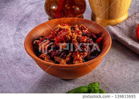 Traditional red kidney bean stew with meat served in a rustic terracotta bowl 139613695