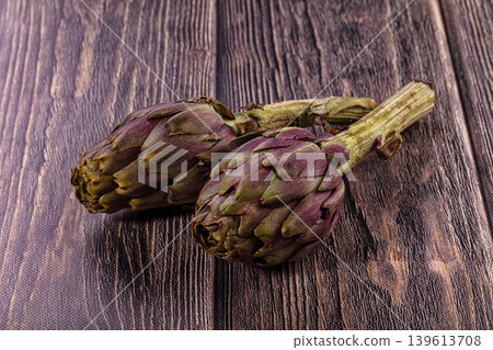 Two Fresh Purple Artichokes on Dark Rustic Wood Background 139613708