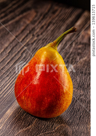 Vibrant Red Yellow Pear on Rustic Wood Surface Vibrant Red Yellow Pear on Rustic Wood Surface 139613715