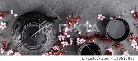 Japanese Tea Set with Cherry Blossoms on Dark Stone Background Japanese Tea Set with Cherry Blossoms on Dark Stone Background 139613952