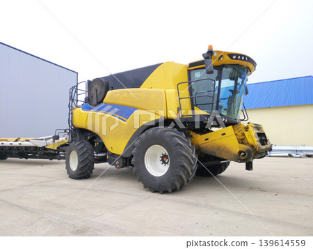 combine harvester is parked before heading out into the field to harvest crops 139614559