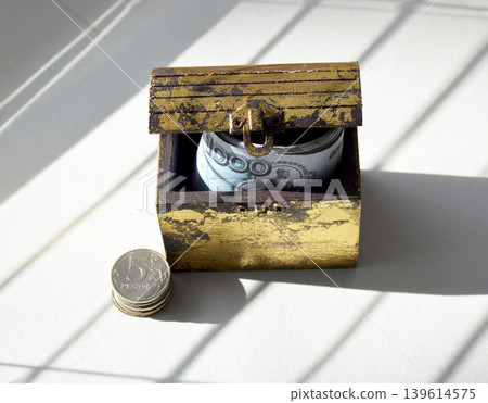 A wooden chest containing coins and Russian rubles. A wooden chest containing coins and Russian rubles. 139614575