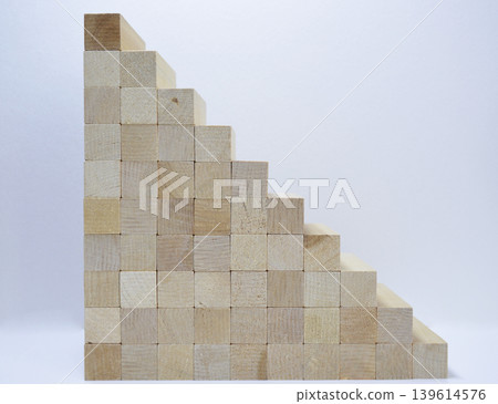A staircase made of wooden blocks on a white background A staircase made of wooden blocks on a white background 139614576