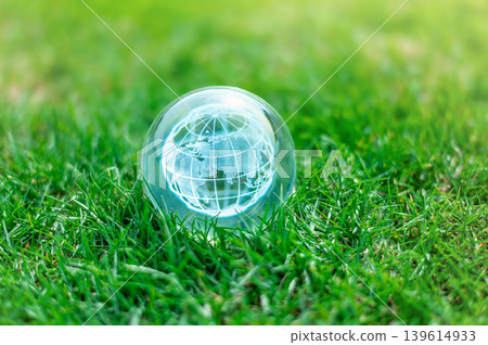 Crystal Glass Globe on Green Grass, Symbol of Environmental Conservation and Sustainability Concept Crystal Glass Globe on Green Grass, Symbol of Environmental Conservation and Sustainability Concept 139614933