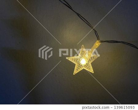 Glowing Star Shaped String Light Close Up On Dark Background Glowing Star Shaped String Light Close Up On Dark Background 139615093