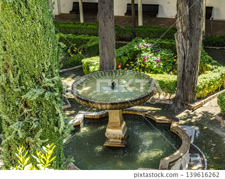 Ornate Stone Fountain in Alhambra Generalife Gardens With Arched Water Jets, Granada Ornate Stone Fountain in Alhambra Generalife Gardens With Arched Water Jets, Granada 139616262