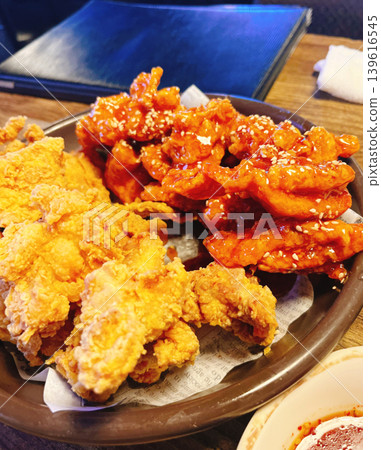 A large platter with two kinds of fried chicken. A large platter with two kinds of fried chicken. 139616545