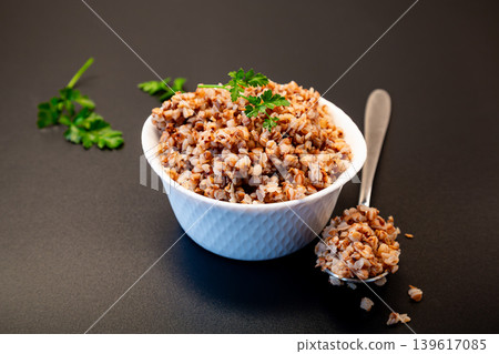 Healthy buckwheat groats served with parsley and spoon Healthy buckwheat groats served with parsley and spoon 139617085